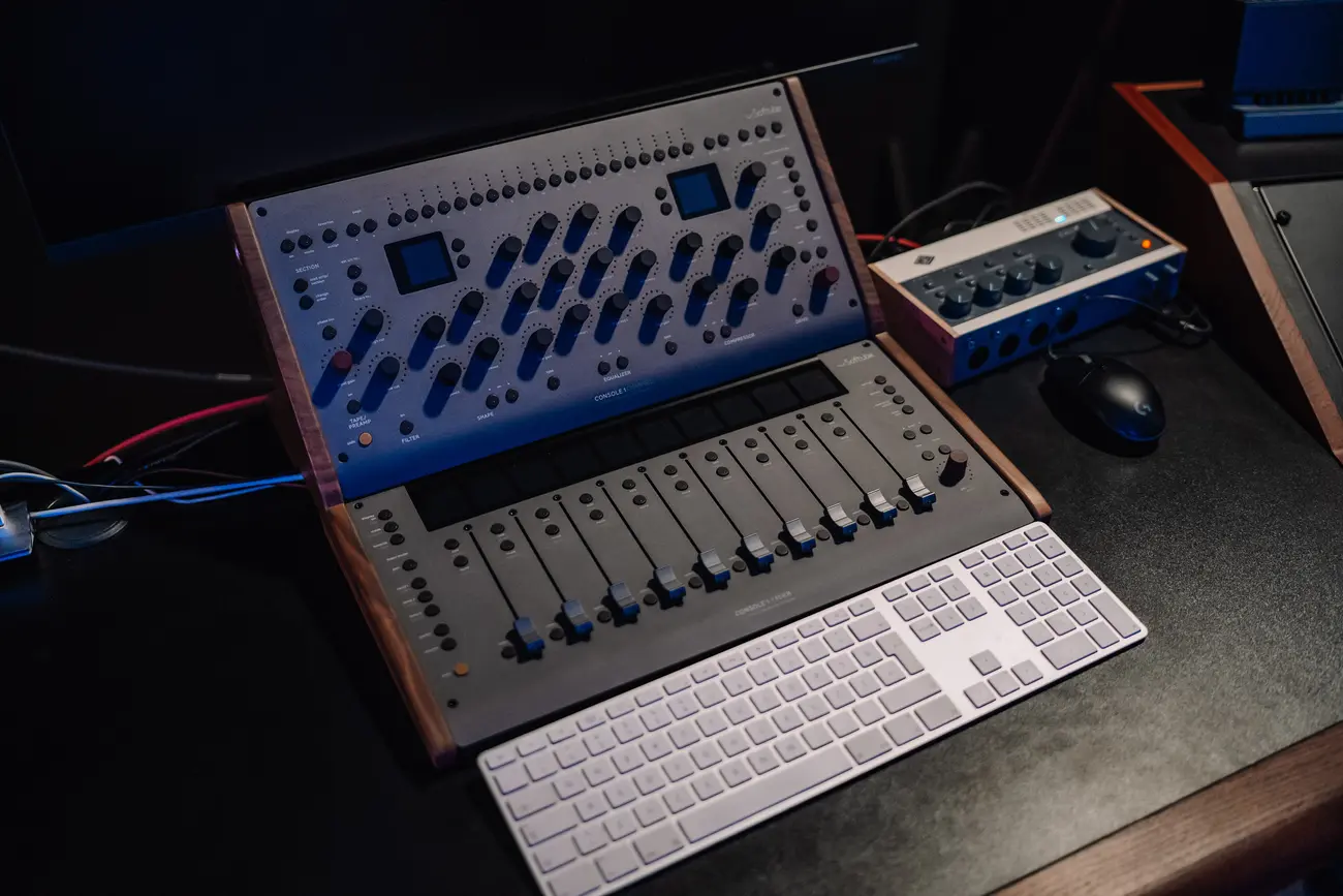 Softube Console 1 Channel and Fader on the mixing desk next to a keyboard